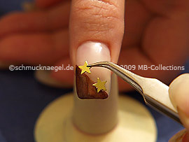 Pinzette und zwei Sterne in der Farbe gold