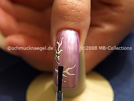 The clear nail lacquer protects the nail art