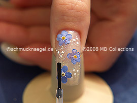 The clear nail lacquer protects the nail art