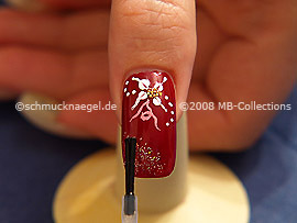 The clear nail lacquer protects the nail art