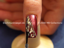 The clear nail lacquer protects the nail art