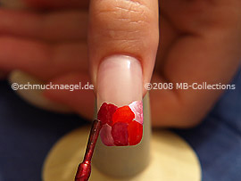 Nail polish in the colour dark red