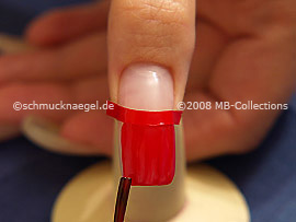 Clear nail lacquer in the colour red