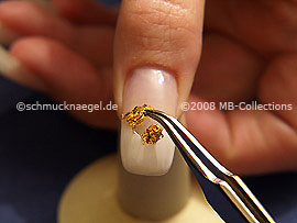 Beaten gold and the tweezers