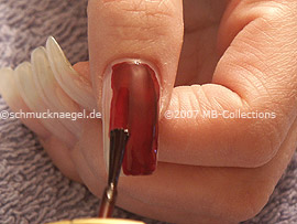 Nail polish in the colour dark red