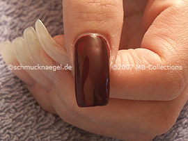 Nail polish in the colour dark red
