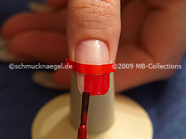 Clear nail lacquer in the colour red