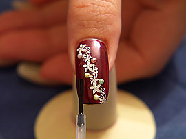 The clear nail lacquer protects the nail art