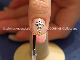 The clear nail lacquer protects the nail art