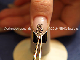 Dragon nail tattoo and tweezers
