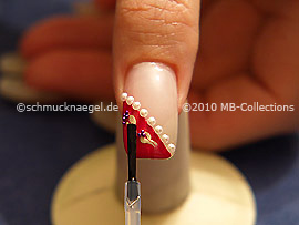 The clear nail lacquer protects the nail art
