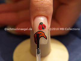 The clear nail lacquer protects the nail art