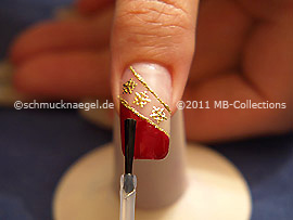 The clear nail lacquer protects the nail art