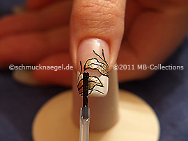 The clear nail lacquer protects the nail art