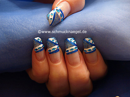 Oval rhinestones and nail lacquer in blue-glitter