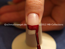 Nail lacquer in the colour dark red