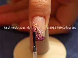 The clear nail lacquer protects the nail art