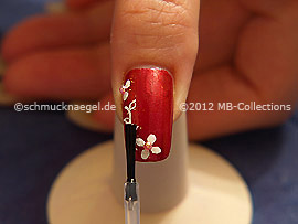 The clear nail lacquer protects the nail art