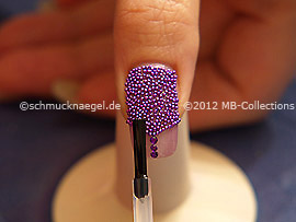 The clear nail lacquer protects the nail art