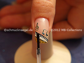The clear nail lacquer protects the nail art