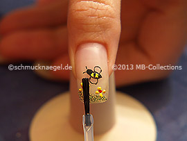 The clear nail lacquer protects the nail art