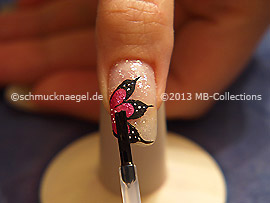 The clear nail lacquer protects the nail art