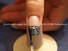 The clear nail lacquer protects the nail art