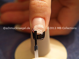 The clear nail lacquer protects the nail art