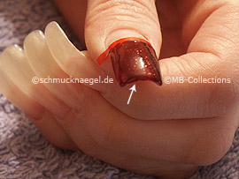 nail lacquer in the colour dark red with glitter