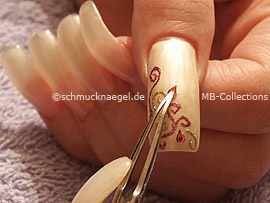 clear nail lacquer, the tweezers and two drop shaped strass stones