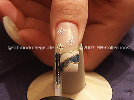 The clear nail lacquer protects the nail art