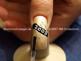 The clear nail lacquer protects the nail art